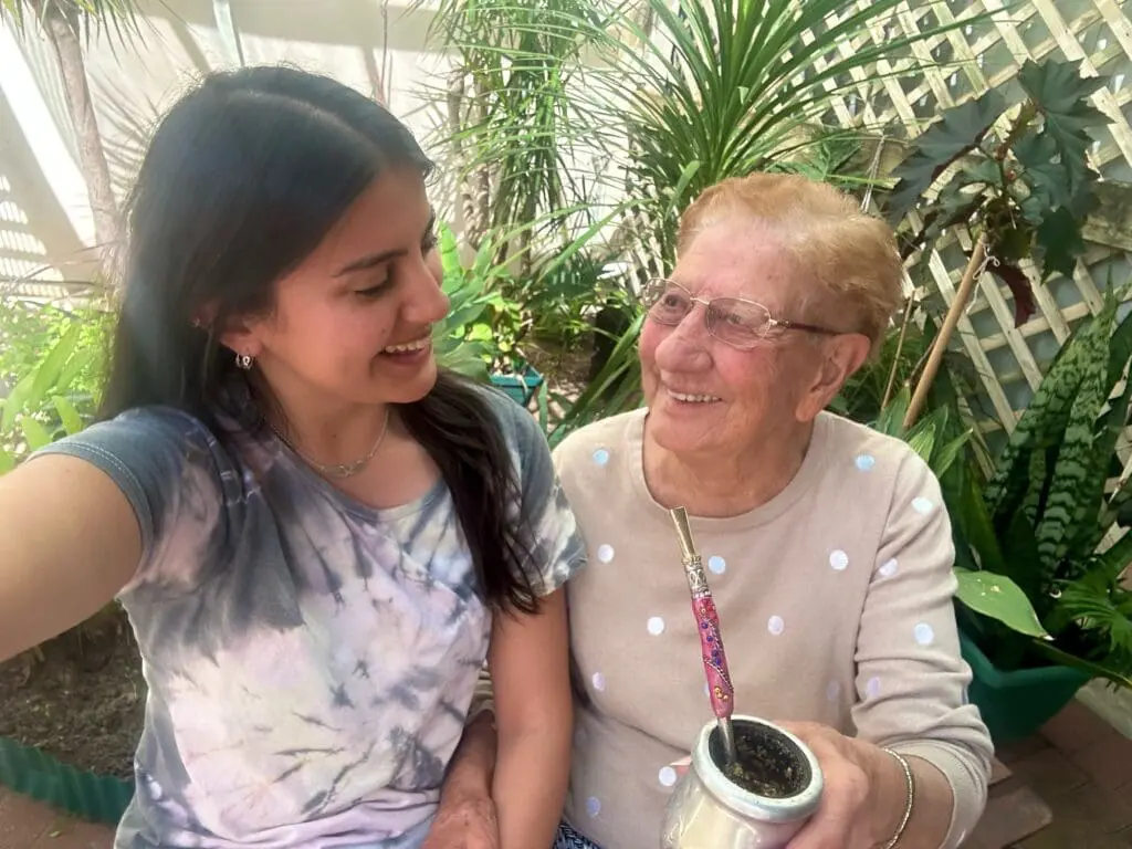 2 intergenerational women enjoying tea together