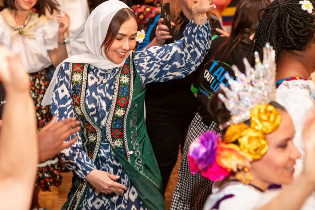 woman with hijab dancing in a crowd