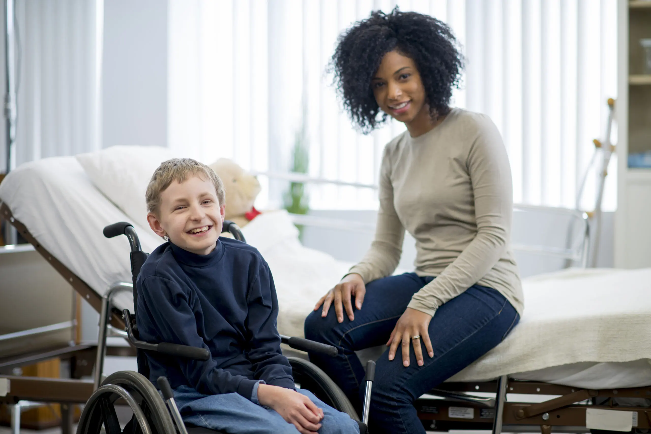 A carer sitting with a child during a health appointment